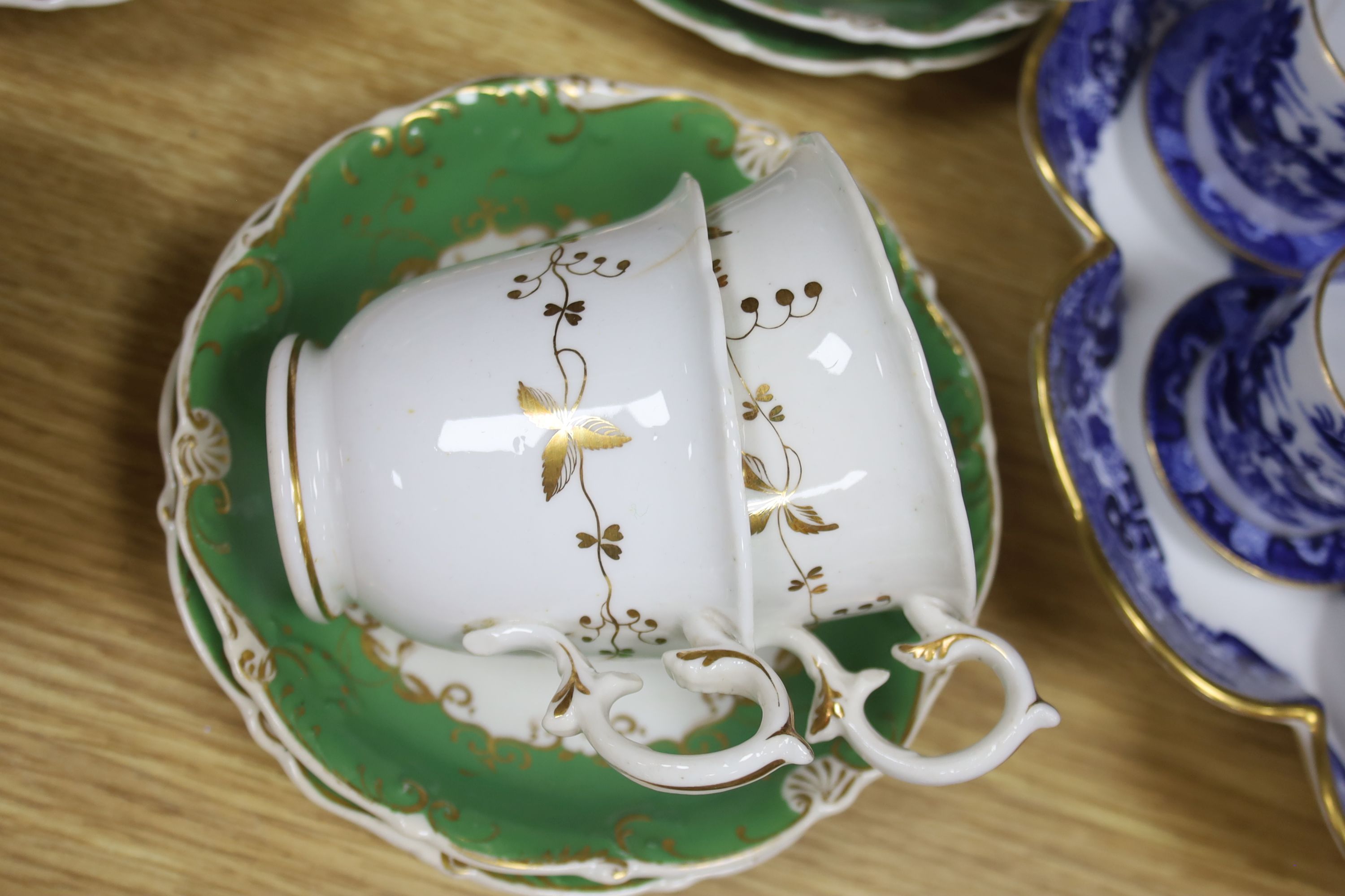 A Copeland blue and white nine cup and saucer cabaret set on stand and a 19th century Rockingham style green and gilt decorated tea ser